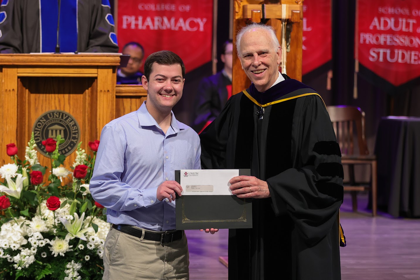 Jack Jenkins (left) accepts the first prize award in the Dr. James Alex Baggett History Research Paper Competition from Dr. Stephen Carls at Union's Awards Day Convocation on April 21, 2023.