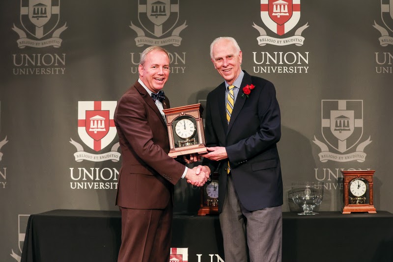 Dr. Stephen Carls (right) accepts a clock and congratulations from President Samuel W. Dub Oliver at the End of Year Employee Celebration Luncheon on May 5, 2023, upon his retirement from teaching at Union University.