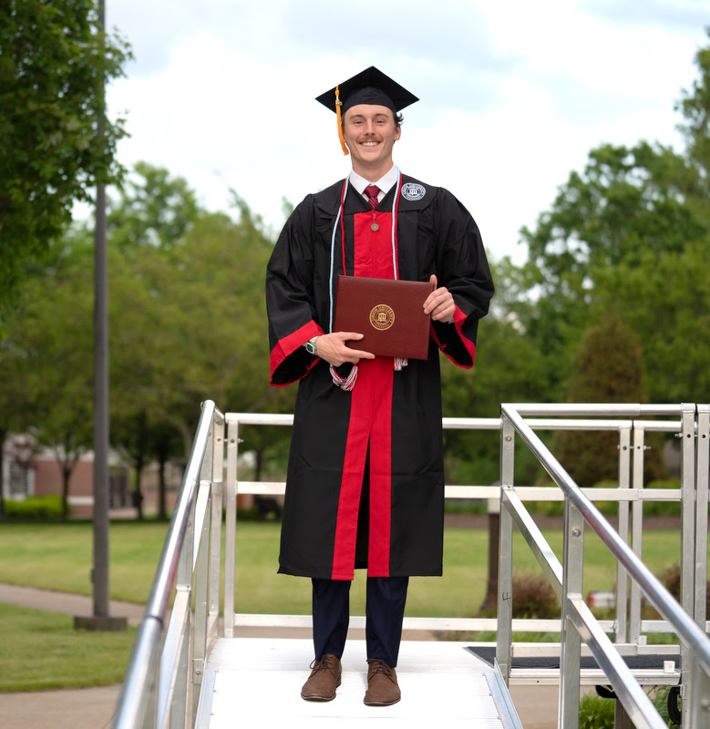 History major and Phi Alpha Theta member Tad Binkley descends from the graduation stage at Union University's spring commencement ceremony on May 6, 2023, after receiving his diploma for completing a Bachelor of Science degree.