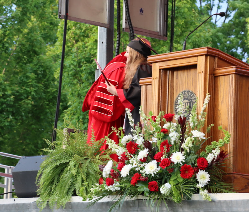 Breanna Edmiston receives a congratulatory hug from Union University President Samual W. Dub Oliver upon receiving her graduation diploma for a Bachelor of Science degree at the school's undergraduate commencement ceremony on May 6, 2023.