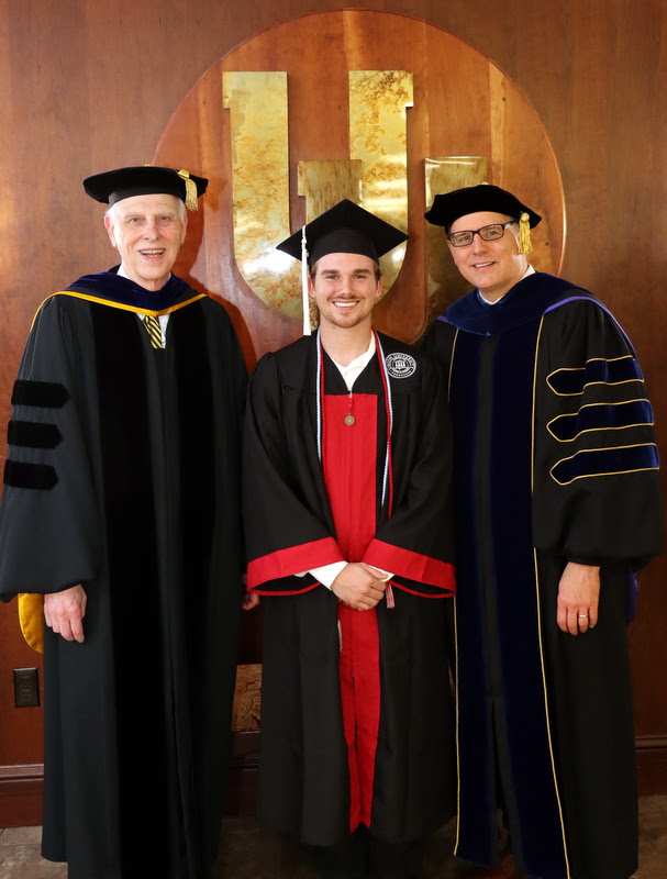 Drs. Stephen Carls (left) and Keith Bates (right) stand with graduating Phi Alpha Theta member Nathan Hicks prior to Union's undergraduate commencement service on May 6, 2023.