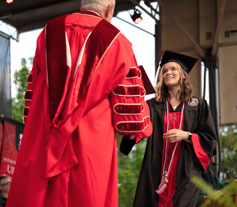 History major and Phi Alpha Theta member Abigail Hobson accepts her diploma for completing a Bachelor of Arts degree program from Union University President Samuel W. Dub Oliver at the institution's undergraduate commencement ceremony on May 6, 2023.