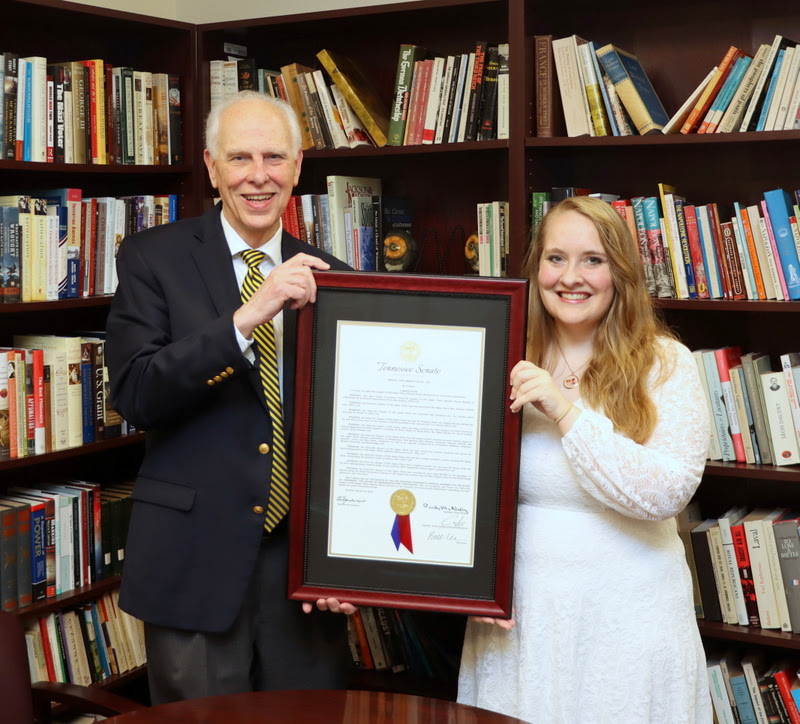 Dr. Stephen Carls and Phi Alpha Theta Vice President Breanna Edmiston on May 6, 2023, hold a framed copy of a Tennessee  Senate Joint Resolution passed in March congratulating Union's Delta-Psi chapter on its 70th anniversary in 2023 (1953-2023).