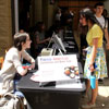 Lauren Butler (left) talks to Phi Alpha Theta member Lillie Salazar near the Lexington Inn during the Delta-Psi chapter's Franco-American bake sale on April 10, 2019.
