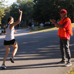 Robert Briley, a Phi Alpha Theta volunteer, cheers on a runner at the Racing So They Can Ride 5k and 10k races in Jackson on September 21, 2019.