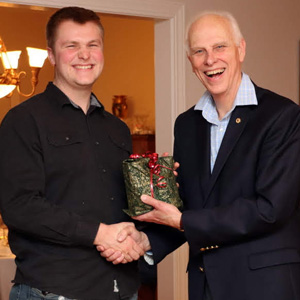 Dr. Stephen Carls (right) congratulates graduating history major Nathan Van Neste during a program at the Phi Alpha Theta/History Department French Christmas Dinner on December 7, 2019.