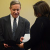 Dr. Henry Allen presents a book and certificate of recognition to Faith Bagley