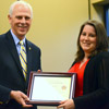 Faith Bagley accepts a certificate of appreciation from Dr. Stephen Carls