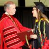 Union University President Dr. Samuel W. Oliver congratulates Bree McCuin after she receives her BS diploma at the school's graduation on May 16, 2015.
