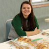 Phi Alpha Theta members Kathryn Mitchell (left) and Jordan Sellers relax as they wait for the second round of the annual Franco-American bake sale to begin in the chapel foyer on March 22, 2017.