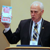 Dr. Stephen Carls presents a Peeps Pink Bunny Gift Pack to Dr. Margaret Lewis, the 2017 Phi Alpha Theta regional conference coordinator, during the luncheon program on April 1, 2017.