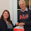 Kathryn Mitchell accepts a graduation award bag from Dr. Stephen Carls at the Phi Alpha Theta cookout on May 12, 2017, in recognition of her successful completion of a bachelor of science program at Union University.