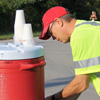 Phi Alpha Theta member Robert Briley fills cups with water during the “Racing So They Can Ride” races on September 16, 2017.