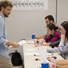 Delta-Psi Chapter Vice President Luke Sower hands out Phi Alpha Theta fact sheets to society members at the chapter's fall plenary meeting on September 20, 2018. Seated are (back to front) Christopher Hearn, Leah Atkins, Audrey Cagle, Megan Ledbetter, and Dr. Keith Bates. Photo by Lynn Tucker