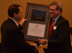 Norm Hill (right), chairman of Union's Board of Trustees, presents a plaque to Gary Carter, senior vice president for business services, during the trustees' Nov. 30 meeting. Trustees recognized Carter and three other Union administrators with awards named in their honor. (Photo by Morris Abernathy)