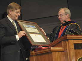 Union President David S. Dockery (right) presents the Robert E. Craig Service Award to Gary Grisham during the Dec. 11 graduation ceremony. (Photo by Morris Abernathy)