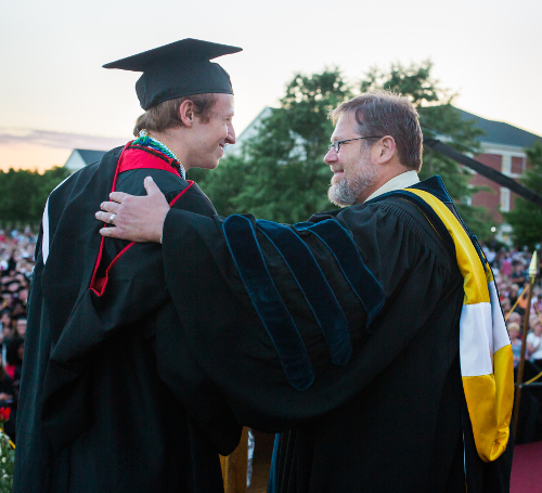 C. Ben Mitchell, provost and vice president for academic affairs, congratulates Tigrett Medal recipient Nathaniel Magnuson at spring commencement May 21. (Photo by Kristi Woody)