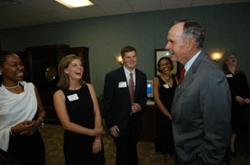 Former President George H.W. Bush laughs with Lauren Oldham, a senior from Martin, Tenn., and other Union students.