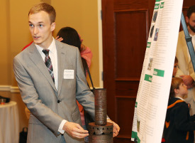 Senior engineering major Matthew Bentley presents his final project at the Scholarship Symposium poster session April 28. (Photo by Kristi Woody)