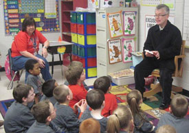 Robbie Graves reads to first graders at Maury City Elementary School. 