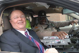 Union trustee Morris Chapman arrives to the Dec. 1 trustee meeting in a state police patrol car, courtesy of state trooper Vester Jones. (Photo by Morris Abernathy)