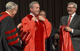 Dub Oliver (center) receives a new presidential robe from Norm Hill (right), chairman of Union's board of trustees, and Hyran Barefoot (left), Union's president from 1986-1996. (Photo by Morris Abernathy)