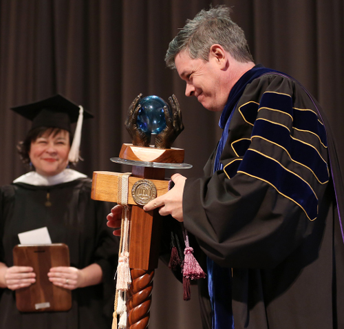 Web Drake takes the mace that is awarded annually to the recipient of Union's Faculty of the Year Award. (Photo by Kristi Woody)