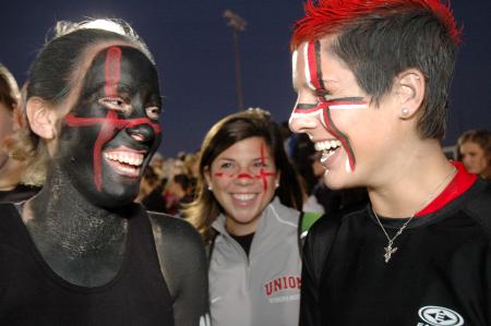 Junior Rachel Fillinger painted herself black while Sophomore Morgan Walley spraypainted her hair red to support their Union bulldogs during the Lambuth vs. Union Blackout game.  - Photo by Beth Spain