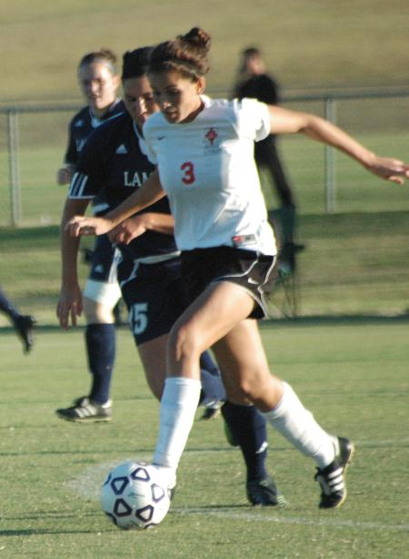 Julie Ocampos-Barry moves the ball up the field ahead of a Lambuth defender.  Union won the match 2-0. - Photo by Tommy Sadler