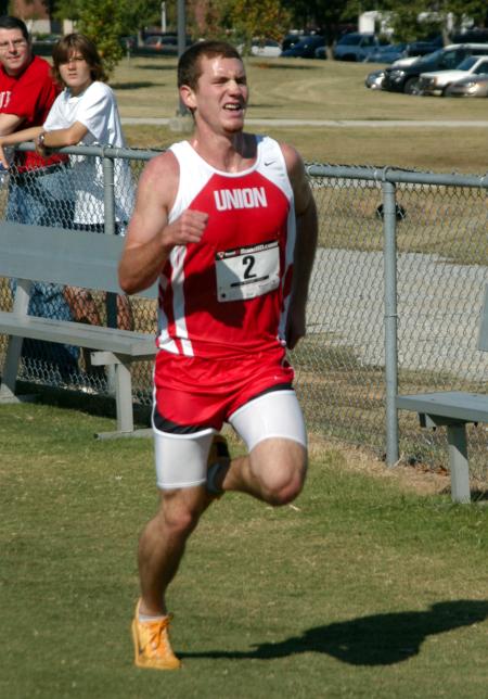 Zach Covington sprints over the final meters during the Union University Cross Country Invitational. - Photo by Steven Aldridge