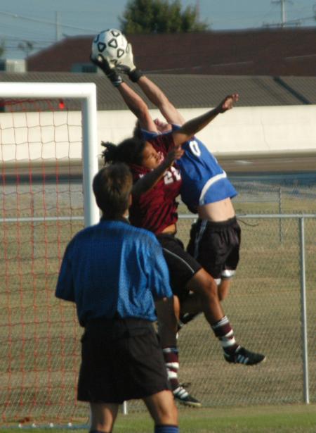 James Landham leaps high over a Cumberland defender for one of his saves. - Photo by Steven Aldridge
