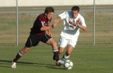 Union's Chris Waugh (25) works against a Cumberland player to control possession of the ball. - Photo by Steven Aldridge