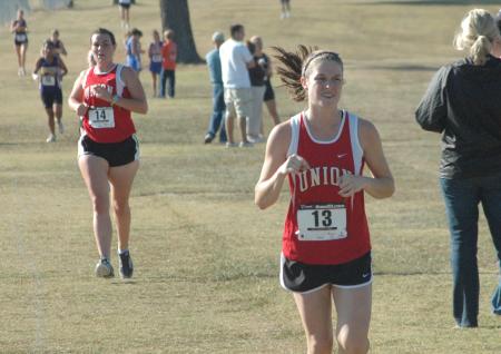 Hannah Staggs (13) races during the Union University Cross Country Invitational.  Teammate Jessi Shubert follows close behind.  Union took first place in the event. - Photo by Tommy Sadler
