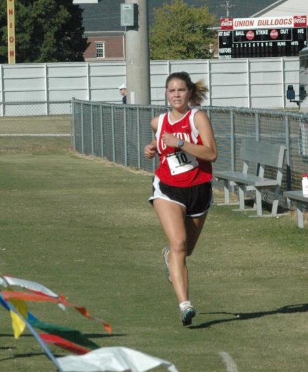 Hannah Clardy crosses the finish line during the Union University Cross Country Invitational.  - Photo by Tommy Sadler
