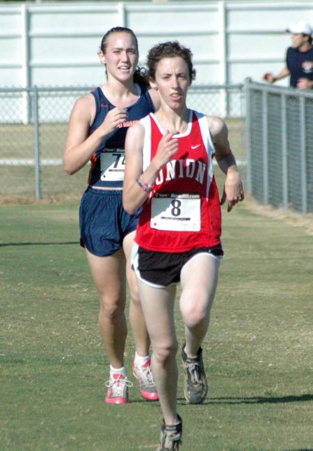 Erika Schnatterly finishes the Union University Cross Country Invitational with competitors in close pursuit. - Photo by Tommy Sadler
