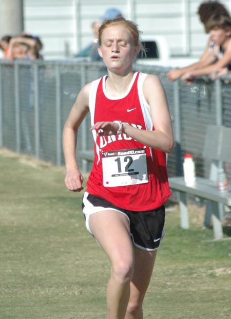 Carissa Wilson runs across the finish line during the Union University Cross Country Invitational. - Photo by Tommy Sadler