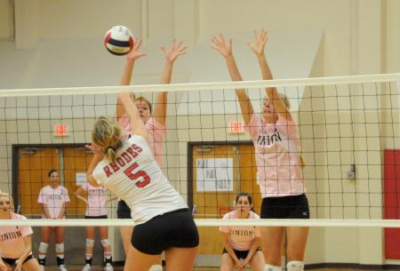 Lady Bulldogs Anna Sims (left) and Amanda Coyle (right) attempt to block a hit by Rhodes (Tenn.) College. - Photo by Morris Abernathy