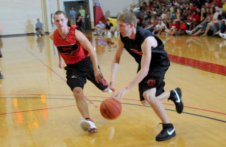Freshman Luke Allison drives to the basket around junior Alan North. - Photo by Morris Abernathy