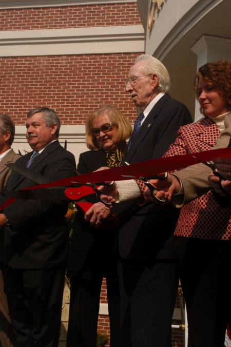 Carl Grant cuts the ribbon at the dedication of the Carl Grant Events Center. - Photo by Angela Abbamonte
