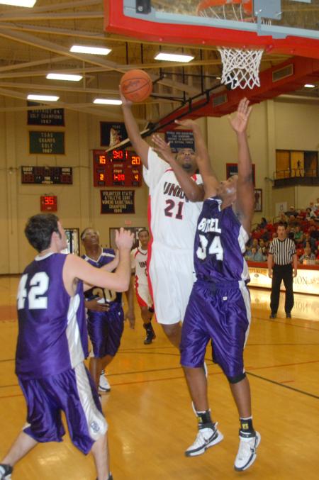 Junior Brian Lake makes a shot over several Bethel (Tenn.) College defenders. - Photo by Morris Abernathy