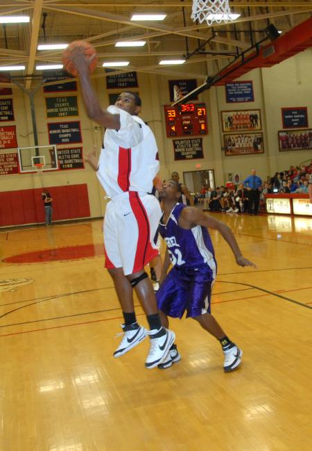 Brian Lake, junior forward, takes a shot around a defender in a game versus Bethel (Tenn.) College. - Photo by Morris Abernathy