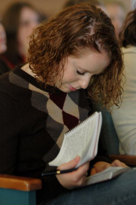 Sophomore social work major Michelle Marks takes note during Russ Pflasterer's sermon on Christ-centered economics. Pflasterer, a 1995 graduate of Union, currently serves as pastor of City Fellowship Baptist Church in Jackson, Tenn. - Photo by Beth Spain