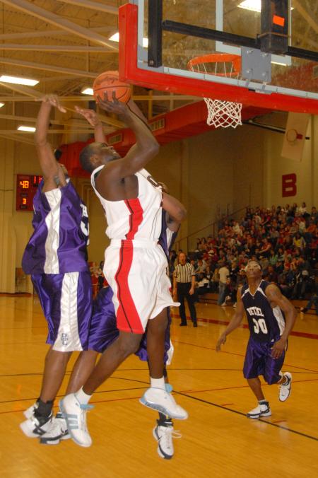 Union freshman Roland Banhoro shoots over two defenders in a conference game against Bethel (Tenn.) College. - Photo by Morris Abernathy