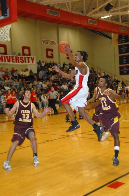 Tacuma Alexander, junior guard, takes a shot between two Freed-Hardeman (Tenn.) University defenders. - Photo by Morris Abernathy