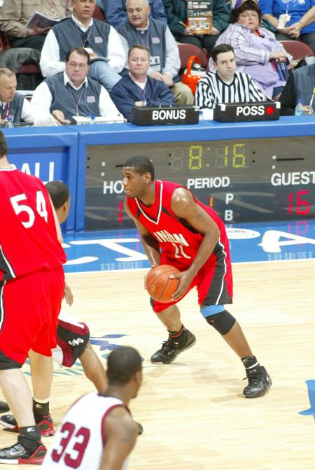 Sophomore forward Brian Lake (21) prepares to pass the ball to a teammate in a game versus Southern Nazarene (Okla.) University during the Sweet Sixteen round of the 2007 NAIA National Tournament. - Photo by Uncredited