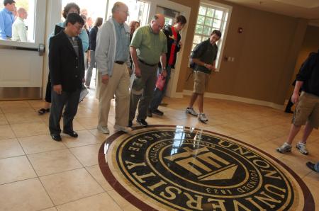 Faculty members Don Van, Richard Dehn and Bryan Dawson take in the beauty of the new flooring the Grant Center. - Photo by Morris Abernathy