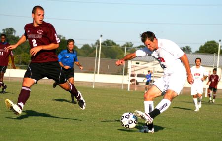 Josh Hanna, junior sport management major, moves the ball against Cumberland University during Family Weekend. - Photo by Kristi McMurry Woody