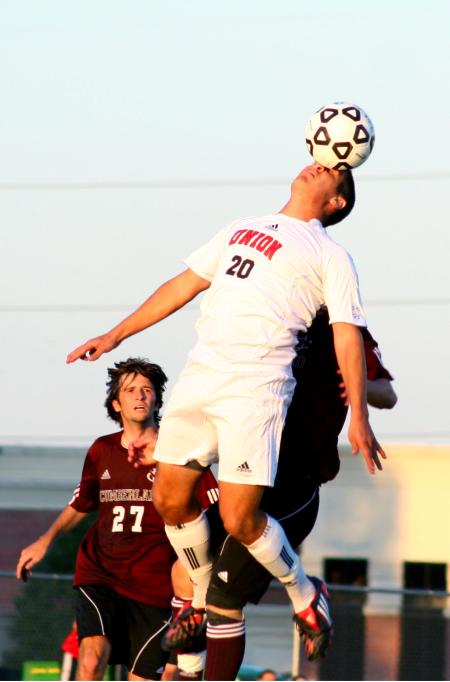 Michael Lee, senior Christian studies major, heads the ball in the Family Weekend game against Cumberland University. - Photo by Kristi McMurry Woody