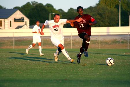 Dejan Kostic (23) fights for the ball against a Cumberland player during a Family Weekend game. - Photo by Kristi McMurry Woody