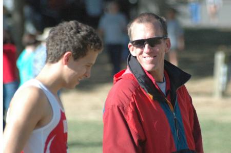 Union cross country head coach, Gary Johnson, talks with Joel Wellum prior to the Union Cross Country Invitational. - Photo by Tommy Sadler